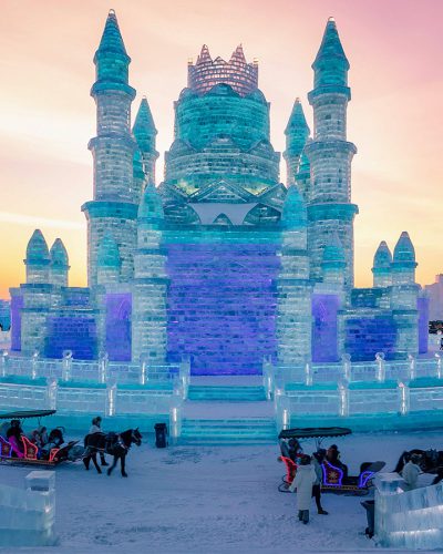 TOPSHOT - This photo taken on December 24, 2018 shows people visiting the Harbin Ice-Snow World in Harbin, China's northeastern Heilongjiang province. - The Harbin Ice and Snow Sculpture Festival will kick off in the city on January 4, 2019, which attracts hundreds of thousands of visitors annually. (Photo by STR / AFP) / China OUT        (Photo credit should read STR/AFP/Getty Images)